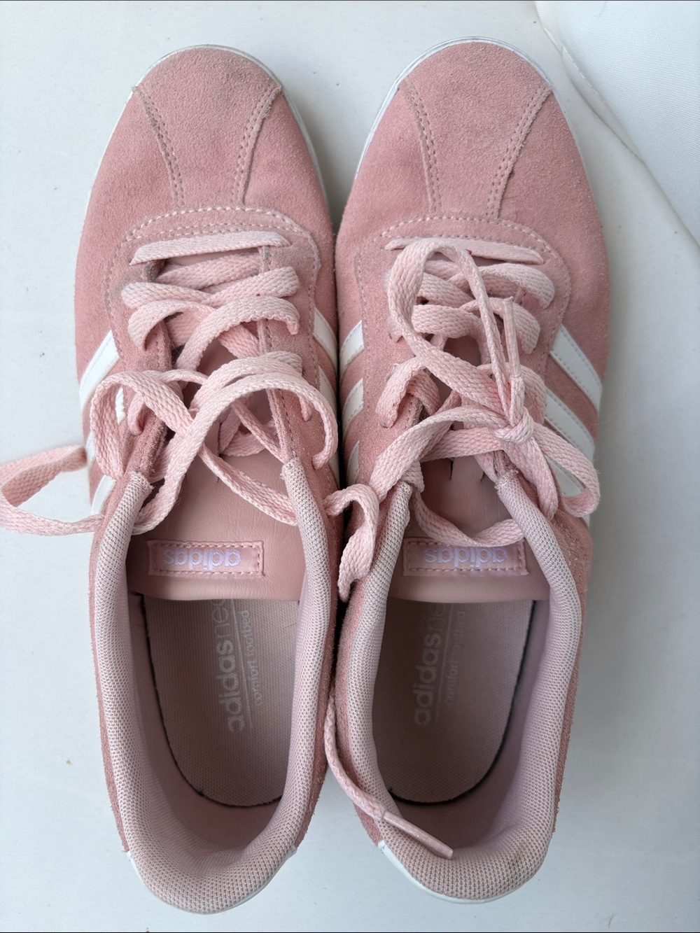 Adidas Neo pink suede sneakers featuring white stripes and a comfort footbed